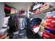 Organized closet with clothing racks, shelves, and shoe boxes for ample storage space at 4465 Shimmering Skies St # 2180, North Las Vegas, NV 89031