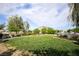 Well-maintained community park with lush green grass, mature trees, and plenty of open space at 4465 Shimmering Skies St # 2180, North Las Vegas, NV 89031