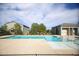 Community pool offers clear blue water, gated access, and a restroom building nearby at 4465 Shimmering Skies St # 2180, North Las Vegas, NV 89031