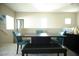 Bright dining area featuring a black dining table with blue chairs and a black bench at 4465 Shimmering Skies St # 2180, North Las Vegas, NV 89031