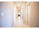 Long hallway with neutral paint and tiled flooring at 4465 Shimmering Skies St # 2180, North Las Vegas, NV 89031