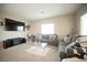 Cozy living room with plush sofas, carpet, and a large TV at 4465 Shimmering Skies St # 2180, North Las Vegas, NV 89031