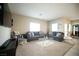 Bright and open living room with neutral colors, carpet, and a large TV at 4465 Shimmering Skies St # 2180, North Las Vegas, NV 89031