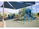 Community playground with climbing structures, slides, and shaded seating areas for to enjoy at 4465 Shimmering Skies St # 2180, North Las Vegas, NV 89031