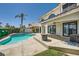 A backyard with a swimming pool, patio, and palm trees is perfect for outdoor enjoyment at 4504 Dunlap Crossing St, Las Vegas, NV 89129