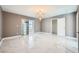 Spacious bedroom with tile floors, modern lighting and sliding glass door to the patio at 4504 Dunlap Crossing St, Las Vegas, NV 89129