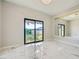 Well-lit bedroom with a sliding glass door to the backyard, features large mirror and marble floors at 4504 Dunlap Crossing St, Las Vegas, NV 89129