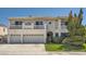 A well maintained two story home with a three car garage and green lawn at 4504 Dunlap Crossing St, Las Vegas, NV 89129