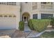 Arched covered entry to home with lush greenery, attached garage on left at 4504 Dunlap Crossing St, Las Vegas, NV 89129