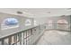 This upstairs landing boasts marble floors, elegant chandeliers, and unique arched windows at 4504 Dunlap Crossing St, Las Vegas, NV 89129