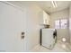 The laundry room has a washer, dryer, and storage cabinets at 4504 Dunlap Crossing St, Las Vegas, NV 89129