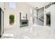 Spacious living room with marble floors, fireplace, and access to second floor at 4504 Dunlap Crossing St, Las Vegas, NV 89129