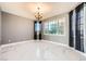 Bright living room featuring elegant chandelier and marble tile flooring at 4504 Dunlap Crossing St, Las Vegas, NV 89129