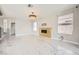 Modern living area with fireplace, marble flooring, and elegant light fixture at 4504 Dunlap Crossing St, Las Vegas, NV 89129