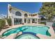 A stunning view of the custom pool and spa with a covered patio in the background at 4504 Dunlap Crossing St, Las Vegas, NV 89129