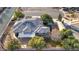 An aerial view of the home with a tile roof, solar panels, a large carport, and a beautiful backyard at 5193 N Miller Ln, Las Vegas, NV 89149