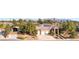 Spacious single-story home with a tile roof, solar panels, desert landscaping, and a three-car garage at 5193 N Miller Ln, Las Vegas, NV 89149