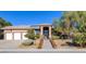 Stunning single-story home features a tile roof, desert landscaping, and an iron gate entrance at 5193 N Miller Ln, Las Vegas, NV 89149