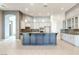 Spacious kitchen features ample cabinetry, stylish granite countertops, and views of open floor plan at 5193 N Miller Ln, Las Vegas, NV 89149