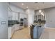 Bright kitchen showcasing stainless steel appliances, granite countertops, and custom white cabinetry at 5193 N Miller Ln, Las Vegas, NV 89149