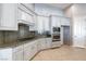 Kitchen with stainless steel appliances, white cabinets, and stone countertops at 5193 N Miller Ln, Las Vegas, NV 89149