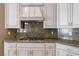 Contemporary kitchen featuring stone backsplash and granite countertops at 5193 N Miller Ln, Las Vegas, NV 89149