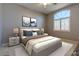 Inviting main bedroom with large window, neutral decor, and comfortable furnishings at 5193 N Miller Ln, Las Vegas, NV 89149