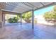 Covered patio with an outdoor fountain, trees, and a landscaped backyard, perfect for entertaining and relaxing at 5193 N Miller Ln, Las Vegas, NV 89149