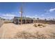 The backyard has a covered patio with a grill and seating, a fire pit, and a large yard at 5463 Waltham Ln, Las Vegas, NV 89122
