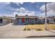 Single-story home features a covered porch, desert landscaping, and solar panels for modern living at 5463 Waltham Ln, Las Vegas, NV 89122