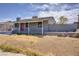 Single-story home has a covered porch, solar panels, and desert landscaping for a low-maintenance lifestyle at 5463 Waltham Ln, Las Vegas, NV 89122
