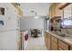 Practical kitchen with light wood cabinets, tiled floor, and adjacent dining area at 5463 Waltham Ln, Las Vegas, NV 89122