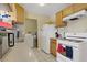 Efficient kitchen with light wood cabinets and appliances with a washer and dryer at 5463 Waltham Ln, Las Vegas, NV 89122
