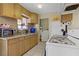 Kitchen area with wood cabinets and white appliances at 5463 Waltham Ln, Las Vegas, NV 89122