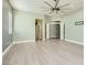 Large bedroom featuring a ceiling fan, neutral paint, base trim, and multiple doorways with ample natural light at 5790 Douglas Everett St, Las Vegas, NV 89120