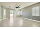 A bright and airy bedroom features multiple windows and a sliding glass door for ample natural light and outdoor access at 5790 Douglas Everett St, Las Vegas, NV 89120