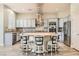 Modern kitchen features gray cabinets, a large center island with bar seating, and a stainless steel refrigerator at 5790 Douglas Everett St, Las Vegas, NV 89120