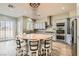 Gourmet kitchen boasting an island with bar seating, stainless steel appliances, and stylish pendant lighting at 5790 Douglas Everett St, Las Vegas, NV 89120