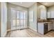 Bright kitchen area with stainless steel appliances, granite countertops, and sliding glass door for outdoor access at 5790 Douglas Everett St, Las Vegas, NV 89120