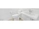 A modern bathroom features a white toilet and pedestal sink at 600 N Carriage Hill Dr # 2098, Las Vegas, NV 89138