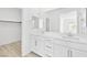 Modern bathroom with double vanity, large mirrors, and bright lighting at 600 N Carriage Hill Dr # 2098, Las Vegas, NV 89138