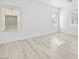 An airy bedroom with light wood flooring and three large windows at 600 N Carriage Hill Dr # 2098, Las Vegas, NV 89138