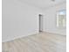 A bright, empty bedroom featuring wood flooring and a window at 600 N Carriage Hill Dr # 2098, Las Vegas, NV 89138