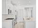 Modern kitchen with white cabinets, island, and stainless appliances at 600 N Carriage Hill Dr # 2098, Las Vegas, NV 89138