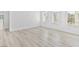 Bright living room with light wood flooring, white walls, and three large windows at 600 N Carriage Hill Dr # 2098, Las Vegas, NV 89138