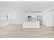 Spacious open-concept living area with kitchen and light wood floors at 600 N Carriage Hill Dr # 2098, Las Vegas, NV 89138