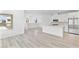 Open-concept living and kitchen area with light wood floors at 600 N Carriage Hill Dr # 2098, Las Vegas, NV 89138