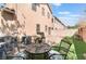 Charming backyard features artificial grass, a paved patio, and an outdoor seating area at 6270 Dartington Hall St, Henderson, NV 89011