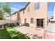 Backyard features a paved patio, artificial grass, and a sliding glass door into the home at 6270 Dartington Hall St, Henderson, NV 89011