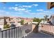 Townhouse community view from a balcony with a black metal railing and satellite dishes at 6270 Dartington Hall St, Henderson, NV 89011